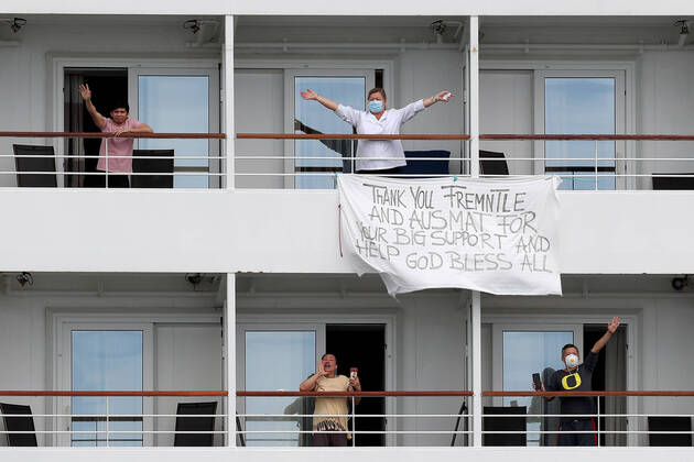 ARTANIA CRUISE SHIP DEPARTURE, Crew members on the cruise ship MV Artania are seen with a sign thanking Fremantle and Australian Medical Assistance Teams (AUSMAT) staff as it departs Fremantle harbour on Saturday, April 18, 2020. The MV Artania arrived in Fremantle over three weeks ago and a reported 79 crew and passengers have tested positive for coronavirus. Two crew members and one passenger have died from the virus.( NO ARCHIVING, EDITORIAL USE ONLY, NO USE IN BOOKS WITHOUT CONSENT PERTH WA AUSTRALIA Copyright: xRICHARDxWAINWRIGHTx 20200418001464079421