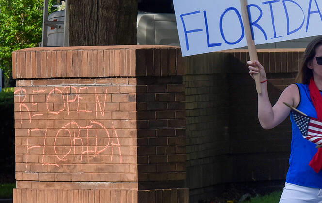April 17, 2020, Orlando, Florida, United States: Reopen Florida is written on a wall with chalk as protesters demonstrate outside the Orange County Administration Building demanding the end of stay-at-home orders and the reopening of Florida businesses as the COVID-19 pandemic keeps thousands of people in their homes and out of work. Orlando United States - ZUMAs197 20200417_zaa_s197_228 Copyright: xPaulxHennessyx