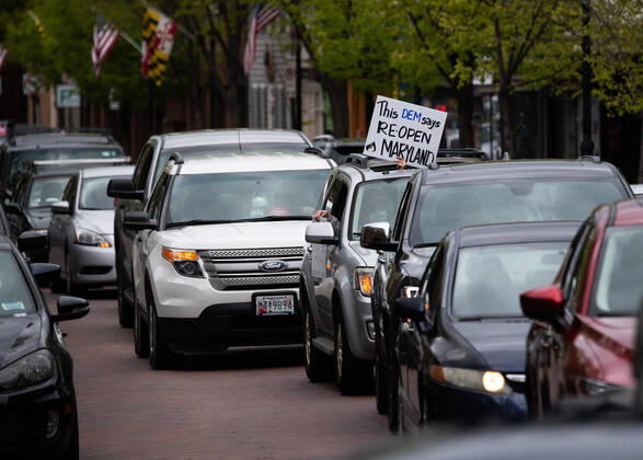 Drivers line their vehicles up during a car protest to reopen Maryland and end the stay at home order imposed during the Coronavirus COVID-19 pandemic, near the state capitol building in Annapolis, Maryland on Saturday, April 18, 2020. Drivers circled Annapolis hoking their horns and calling for Gov. Larry Hogan (R-MD) to end the stay at home order.  WAP20200418313 KEVINxDIETSCH