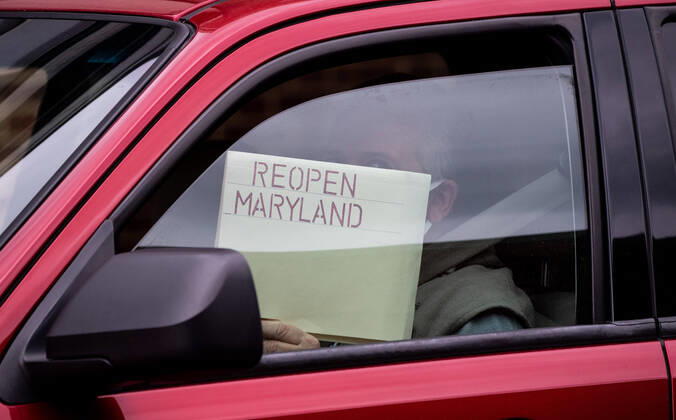 Drivers line their vehicles up during a car protest to reopen Maryland and end the stay at home order imposed during the Coronavirus COVID-19 pandemic, near the state capitol building in Annapolis, Maryland on Saturday, April 18, 2020. Drivers circled Annapolis hoking their horns and calling for Gov. Larry Hogan (R-MD) to end the stay at home order.  WAP20200418314 KEVINxDIETSCH