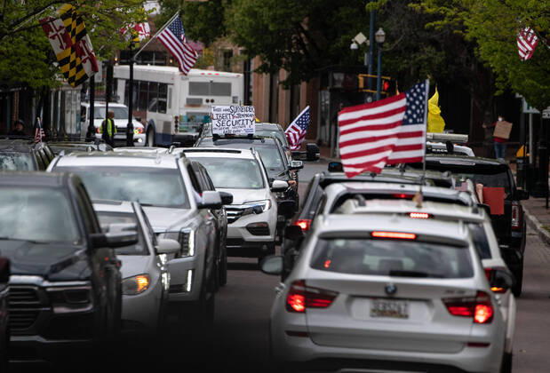 Vehicles line up during a protest to reopen Maryland and end the stay at home order imposed during the Coronavirus COVID-19 pandemic, near the state capitol building in Annapolis, Maryland on Saturday, April 18, 2020. Drivers circled Annapolis hoking their horns and calling for Gov. Larry Hogan (R-MD) to end the stay at home order.  WAP20200418321 KEVINxDIETSCH