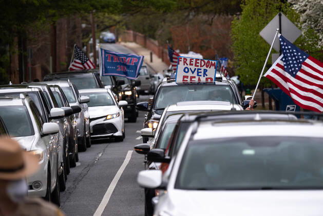 Drivers in vehicles participate in a car protest to reopen Maryland and end the stay at home order imposed during the Coronavirus COVID-19 pandemic, near the state capitol building in Annapolis, Maryland on Saturday, April 18, 2020. Drivers circled Annapolis hoking their horns and calling for Gov. Larry Hogan (R-MD) to end the stay at home order.  WAP20200418327 KEVINxDIETSCH
