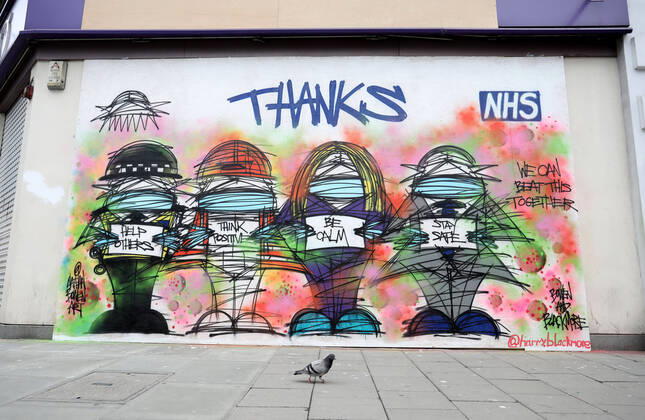 Day Twenty Six of Lockdown in London. A pigeon walks past a grafitti mural giving thanks to the NHS in a very quiet central London for a Saturday as the country is on lockdown due to the COVID-19 Coronavirus pandemic. People are not allowed to leave home except for minimal food shopping, medical treatment, exercise - once a day, and essential work. COVID-19 Coronavirus lockdown, London, UK, on April 18, 2020 