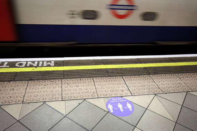 Day Twenty Six of Lockdown in London. Stickers on the platform advising of social distancing at London Kings Cross underground station on a very quiet Saturday as the country is on lockdown due to the COVID-19 Coronavirus pandemic. People are not allowed to leave home except for minimal food shopping, medical treatment, exercise - once a day, and essential work. COVID-19 Coronavirus lockdown, London, UK, on April 18, 2020 