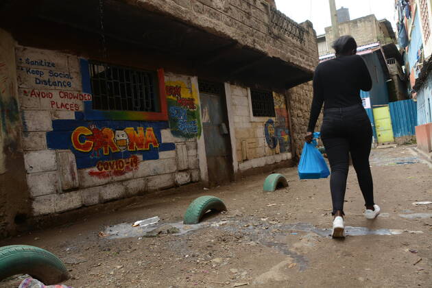 April 19, 2020, Nairobi, Kenya: A woman walks past a graffiti by Anthony Kihoro in Kayole sensitising people about Coronavirus..President Uhuru Kenyatta on March 25, 2020 imposed a dusk-to-dawn 21 day curfew from (7pm-5am) that took effect on Friday, March 26, 2020 in order to curb the spread of COVID-19. Kenya has so far recorded 270 cases of the Coronavirus, 67 recoveries and 14 deaths. Nairobi Kenya - ZUMAs197 20200419_zab_s197_001 Copyright: xDennisxSigwex
