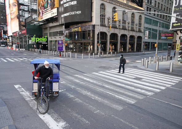 A pedestrian and a man riding a rickshaw occupy a crosswalk on 7th Avenue in a nearly empty of pedestrian and automobile traffic Times Square on Easter Sunday of Orthodox Easter weekend in New York City on Sunday, April 19, 2020. The world s Orthodox Christians are celebrating Easter through a series of restrictions and bans including closures of churches due to the Coronavirus pandemic. More than 13,300 people with COVID-19 have died in New York State.  NYP20200419115 JOHNxANGELILLO