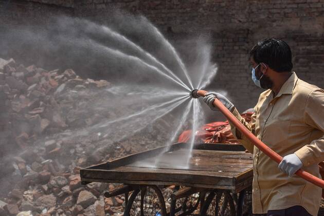 NEW DELHI, INDIA - APRIL 21: MCD worker chemically sanitizes an area in Jahangirpuri C Block one of the coronavirus containment zone, on April 21, 2020 in New Delhi, India. (Photo by Sanchit Khanna Hindustan Times) Sanitization Drive To Curb The Spread Of Coronavirus COVID-19