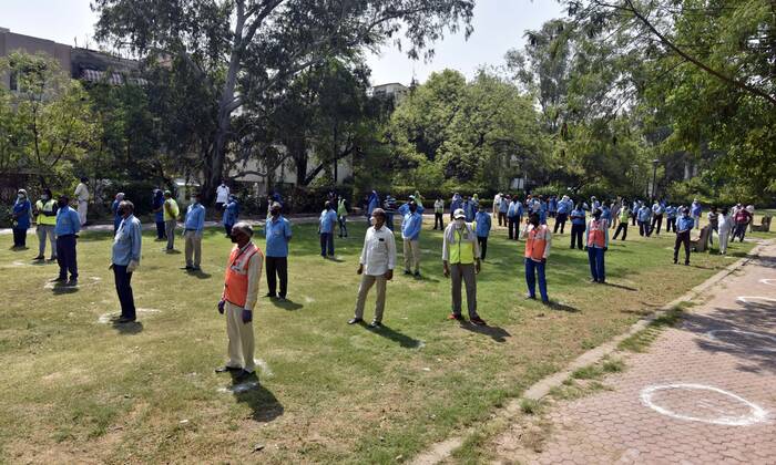 NEW DELHI, INDIA - APRIL 21: Cleaning staff queue to collect PPE kits distributed by Defence Colony welfare groups in association with SDMC during lockdown, at Defence Colony, on April 21, 2020 in New Delhi, India. (Photo by Sanjeev Verma Hindustan Times) PPE Kits Distributed To SDMC Sanitation Staff