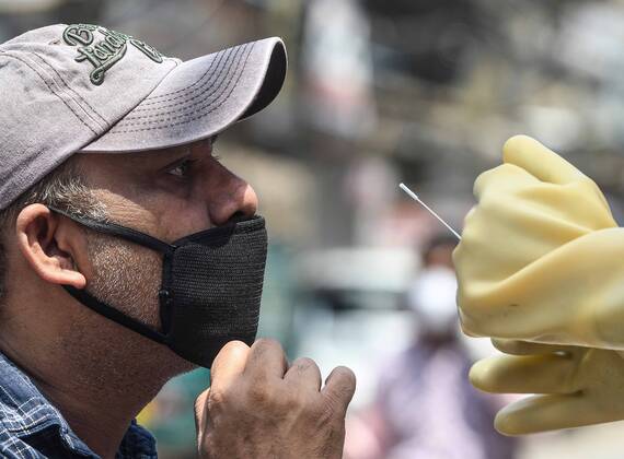 NEW DELHI, INDIA - APRIL 21: Health workers in a mobile testing van take swab samples from residents of the Hauz Qazi area for COVID-19 antibody rapid testing as a precautionary measure during lockdown on April 21, 2020 in New Delhi, India. (Photo by Biplov Bhuyan Hindustan Times) Antibody Rapid Testing In Delhi In View Of Covid-19 Pandemic