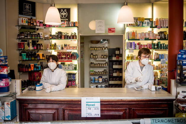 April 22, 2020, Barcelona, Catalonia, Spain: Two pharmacists wearing safety masks and keeping distance attend customers in Barcelona. Spain will begin deescalation of coronavirus measures without knowing the incidence of the epidemic, coronavirus deaths stabilize with 435 in the past 24 hours. Barcelona Spain - ZUMAb137 20200422_zap_b137_001 Copyright: xJordixBoixareux
