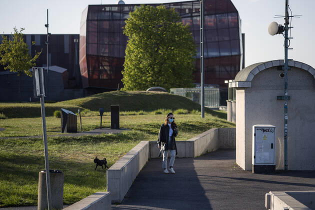 April 22, 2020, Warsaw, Mazowieckie, Poland: A woman wearing a face mask as a precaution while walking her dog during the Covid-19 pandemic..The Polish government softened some of the restrictions related to the Covid-19 pandemic. Citizens are now allowed to walk in parks, more customers are allowed to enter shops. Protective masks are still obligatory for every citizen in public space. Warsaw Poland - ZUMAs197 20200422_zaa_s197_104 Copyright: xAttilaxHusejnowx