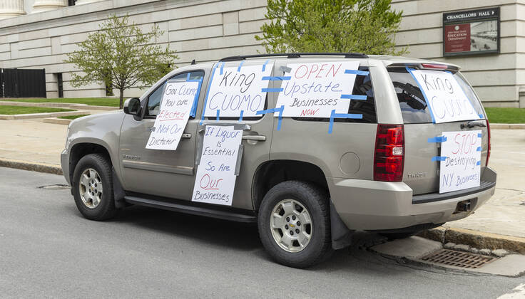 NY: Operation Gridlock in Albany Car plastered with posters seen during Operation Gridlock protest outside of New York State Capitol Building. Participants demanded reopening of New York State. Many people on the street disregarded wearing facial masks and keep social distances. Albany New York United States Copyright: LevxRadin