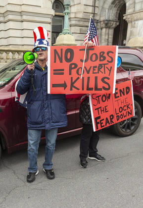 NY: Operation Gridlock in Albany People in cars and on streets with American flags and Trump flags participate in Operation Gridlock protest outside of New York State Capitol Building. Participants demanded reopening of New York State. Many people on the street disregarded wearing facial masks and keep social distances. Albany New York United States Copyright: LevxRadin