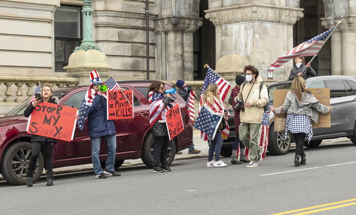 NY: Operation Gridlock in Albany People in cars and on streets with American flags and Trump flags participate in Operation Gridlock protest outside of New York State Capitol Building. Participants demanded reopening of New York State. Many people on the street disregarded wearing facial masks and keep social distances. Albany New York United States Copyright: LevxRadin