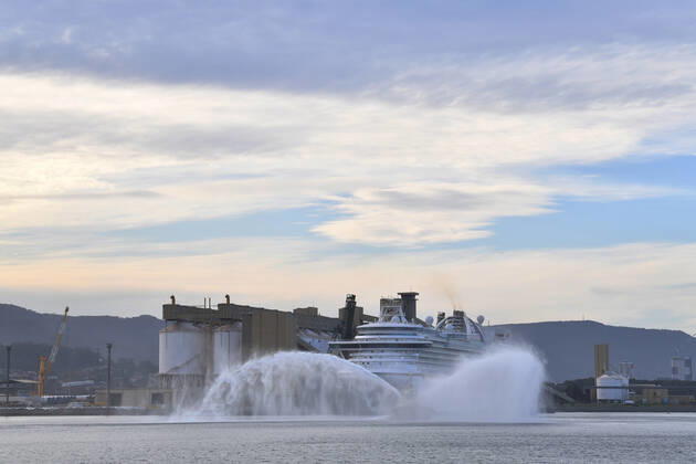 RUBY PRINCESS DEPARTURE, A tug sprays water as the Ruby Princess cruise ship prepares to depart Port Kembla in Wollongong, New South Wales, Thursday, April 23, 2020. The Ruby Princess cruise ship has been told to leave Australia by Thursday, as an inquiry begins. ( NO ARCHIVING, EDITORIAL USE ONLY, NO USE IN BOOKS WITHOUT CONSENT SYDNEY NSW AUSTRALIA  Copyright: xx 20200423001464863828