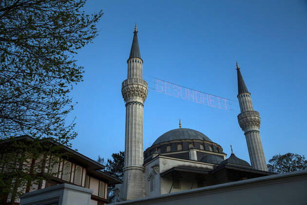 The writing Health shines between the minarets of the closed Sehitlik mosque in Berlin on 23 April 2020 Today begins the month of Ramadam Coronavirus in Berlin, which is holy for Islam