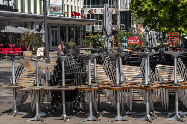 Stacked chairs and tables from various catering establishments, on Kennedyplatz, closed cafes, pubs, restaurants, effects of the corona crisis in Essen, Germany
