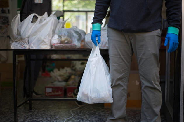 Spain: Food distribution due to Covid-19 crisis A volunteer delivers food at the Aluche Neighbors Association Madrid Madrid Spain Copyright: FerxCapdeponxArroyo