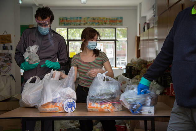 Spain: Food distribution due to Covid-19 crisis Three volunteers deliver food to the doors of the Aluche Neighbors Association Madrid Madrid Spain Copyright: FerxCapdeponxArroyo