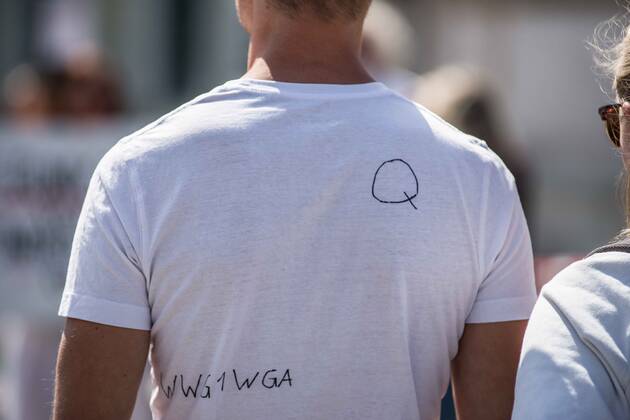 April 25, 2020, Munich, Bavaria, Germany: A follower of the QAnon conspiracies at a demo in Munich, Germany. Organized in Telegram chats by conspiratorial â€oeQuerfront†(cross-front) groups, the city of Munich, Germany saw numerous QAnon-like, â€oeCorona Parties†as under mottos such as â€oeDemonstration fuer die Erhaltung der Grundrechte†(Demonstration for the Upholding of Basic Rights) and â€oeFuer unsere Freiheit, unsere Grundrechte und unsere Selbstbestimmung†(Demonstration for our Freedom, Basic Rights, and Self-Determination). Numerous right-extremists, Verfassungsschutz-monitored figures, QAnon fans, and AfD politicians were in attendance. The groups are of the belief that the anti-Coronavirus measures are power-grabs. Querfront groups are often a mix of political outliers, AfD members, - ZUMAb160 20200425_zbp_b160_013 Copyright: xSachellexBabbarx