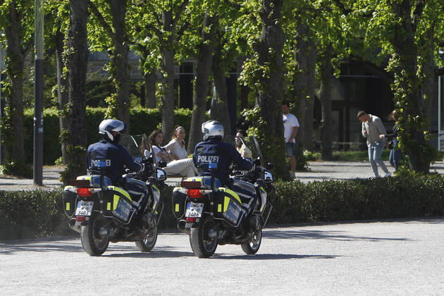 A police patrol of the Baden Württemberg State Police checks the compliance with the contact prohibitions and minimum distances on the Schlossplatz in the city centre of Karlsruhe, Baden Württemberg, Bavaria, Germany