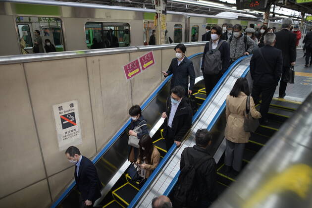 TOKYO, JAPAN - APRIL 27: Commuters wearing face mask head to work early morning during a rush hour in Tokyo amid concerns of the COVID-19 coronavirus on Monday, April 27, 2020. Japanese Prime Minister Shinzo Abe declared a nationwide State of Emergency last week urging people to stay home to prevent the spreading of the coronavirus throughout the country. (Photo: Richard Atrero de Guzman AFLO)  (125743148)