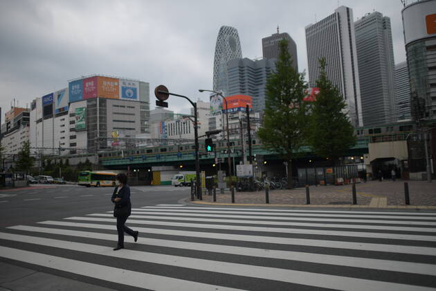 TOKYO, JAPAN - APRIL 27: A woman wearing face mask walk across the street in Tokyo amid concerns of the COVID-19 coronavirus on Monday, April 27, 2020. Japanese Prime Minister Shinzo Abe declared a nationwide State of Emergency last week urging people to stay home to prevent the spreading of the coronavirus throughout the country. (Photo: Richard Atrero de Guzman AFLO)  (125743187)