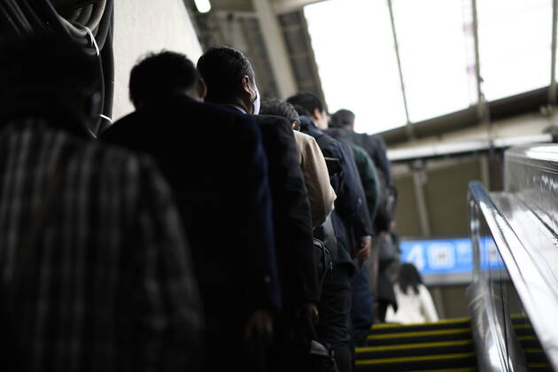 TOKYO, JAPAN - APRIL 27: Commuters wearing face mask head to work early morning during a rush hour in Tokyo amid concerns of the COVID-19 coronavirus on Monday, April 27, 2020. Japanese Prime Minister Shinzo Abe declared a nationwide State of Emergency last week urging people to stay home to prevent the spreading of the coronavirus throughout the country. (Photo: Richard Atrero de Guzman AFLO)  (125743255)