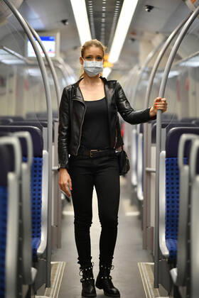 Woman with face mask, standing in S Bahn, Corona crisis, Stuttgart, Baden Württemberg, Germany Coronavirus