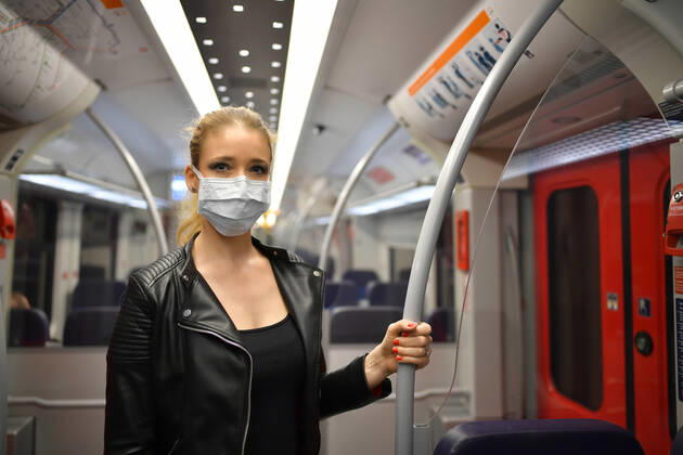 Woman with face mask, standing in S Bahn, Corona crisis, Stuttgart, Baden Württemberg, Germany Coronavirus