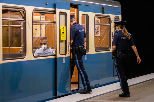 (200428) -- MUNICH, April 28, 2020 (Xinhua) -- Two policemen wearing face masks walk into a subway cabin in Munich, Germany, April 27, 2020. In most German states, face masks or an equivalent mouth-and-nose cover have become mandatory on Monday when people travel by bus or train or go shopping. (Photo by Kevin Voigt Xinhua) GERMANY-MUNICH-COVID-19-FACE MASK 