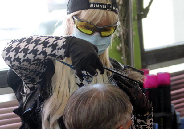 28.04.2020 Belgrade(Serbia) Coronavirus Covid-19 Life loosening measures Friseur hair stylist studio Goca Gotza open after 43 days state of emergency.Friseour hairdresser Gordana working with protection mask,gloves and glasses