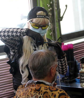 28.04.2020 Belgrade(Serbia) Coronavirus Covid-19 Life loosening measures Friseur hair stylist studio Goca Gotza open after 43 days state of emergency.Friseour hairdresser Gordana working with protection mask,gloves and glasses