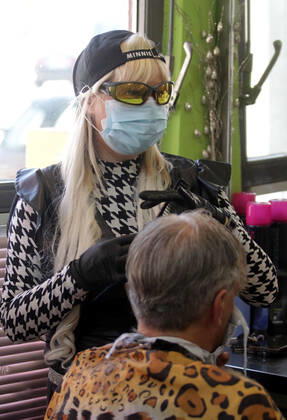 28.04.2020 Belgrade(Serbia) Coronavirus Covid-19 Life loosening measures Friseur hair stylist studio Goca Gotza open after 43 days state of emergency.Friseour hairdresser Gordana working with protection mask,gloves and glasses
