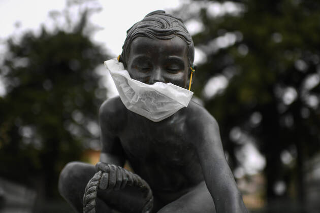 A protective mask is placed on a statue of a child fisherman, in street riviera, in Naples city. Government Decree declaring all of Italy a protected area to combat Covid-19 - Coronavirus infection. Copyright: xSalvatorexLaportax xIPAx xKontrolabx