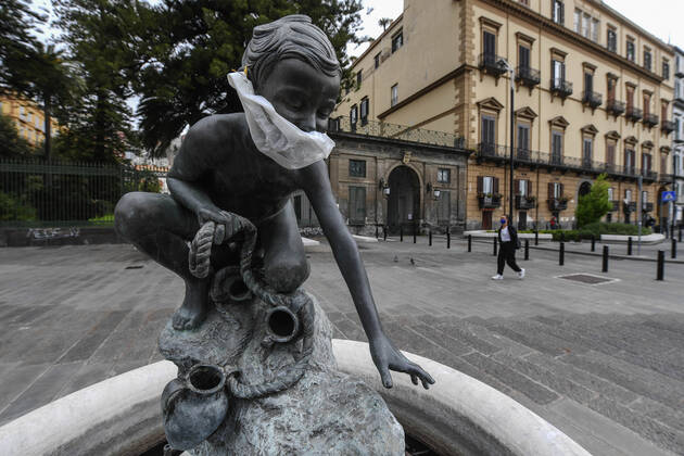 A protective mask is placed on a statue of a child fisherman, in street riviera, in Naples city. Government Decree declaring all of Italy a protected area to combat Covid-19 - Coronavirus infection. Copyright: xSalvatorexLaportax xIPAx xKontrolabx
