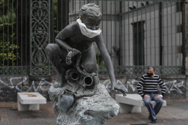 A protective mask is placed on a statue of a child fisherman, in street riviera, in Naples city. Government Decree declaring all of Italy a protected area to combat Covid-19 - Coronavirus infection. Copyright: xSalvatorexLaportax xIPAx xKontrolabx