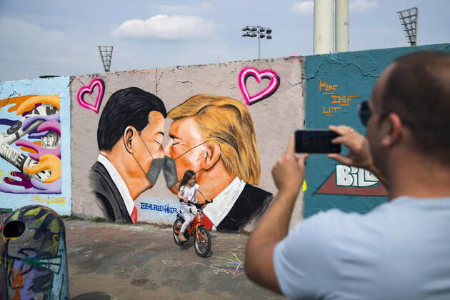 Graffiti by artist Eme Freethinker with USA President Donald Trump and Chinese President Xi Jinping kissing each other with a face mask at Mauerpark in Berlin on April 28, 2020 Since yesterday, it is mandatory to wear nose and mouth protection on trains, trams and busses Starting tomorrow, it will also be mandatory for retailers Coronavirus in Berlin