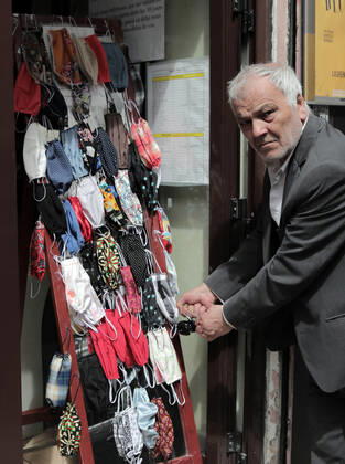 A tailor tends to self-made cotton masks for sale at his shop in Paris, France, Tuesday April 28, 2020. The French premier announced today that protective masks, which have been in severe shortage since the outbreak of the pandemic, will be available for everyone starting May 11th.  PAR20200428102 ECOxCLEMENT