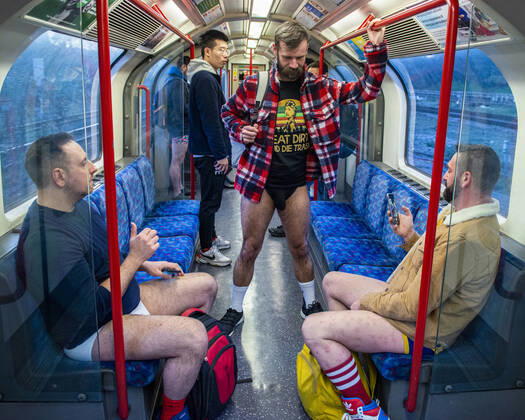 Members of the public take part in the No Trousers Tube Ride 2020 which involves riding on an underground train with no trousers or skirt on and behaving normally by reading a book or listening to music. NR H&M H Copyright: xErnestoxRogata LOOPxIMAGESx ERA01520011