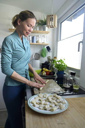Woman preparing gnocchi in kitchen model released Symbolfoto property released ECPF00900