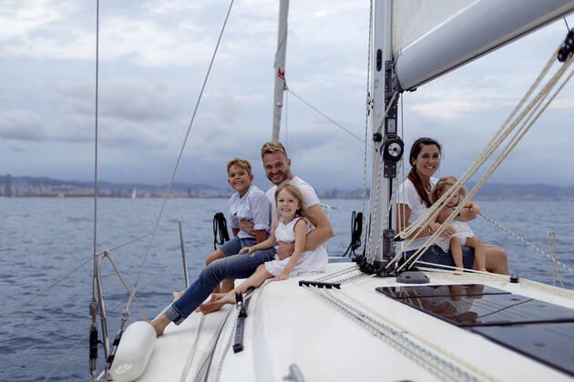Family sitting on deck during sailing trip model released Symbolfoto GMLF00109
