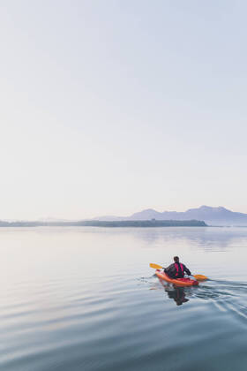 Woman standing on sup board in the morning on a lake, Germany model released Symbolfoto MMAF01313