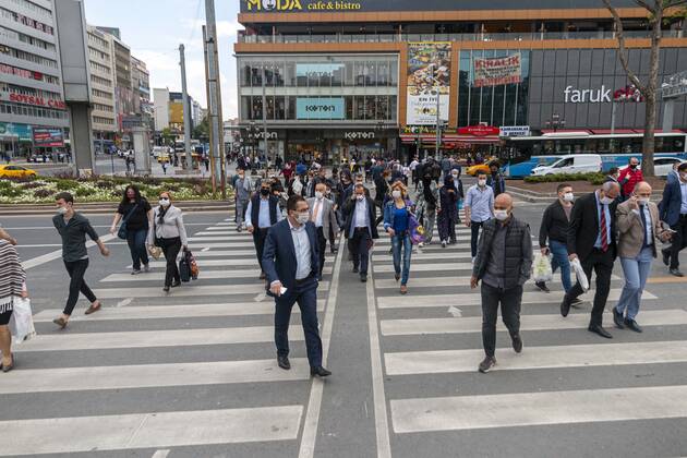 People wearing face masks, walk on a street in Ankara, Turkey, June 01, 2020. Many businesses across Turkey reopen for the first time after over two months of closure amid a slowdown in the spread of COVID-19. Restaurants, cafes, show centers, concert halls, cafes, hookah halls, parks, daycare centers, kindergartens, libraries, sports facilities, swimming pools, and museums operational from June 1 as part of the new normalization process. The Ministry announced on 1 June that normalization steps would be taken in Turkey. As businesses opened as part of the steps taken, Life began to return to normal, the country s capital city, Ankara. TunahanxTurhanx xINAxPhotoxAgency 1048_02_IMG_7433