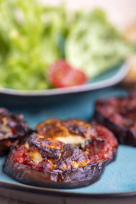 grilled eggplants with cheese and salad 1035306816