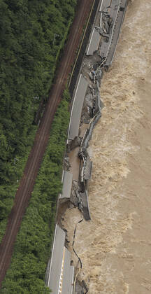 Torrential rain in central Japan Photo taken from a Kyodo News helicopter on July 8, 2020, shows a collapsed section of national road Route 41 after torrential rain caused the Hida River in Gero in Gifu Prefecture, central Japan, to swell.