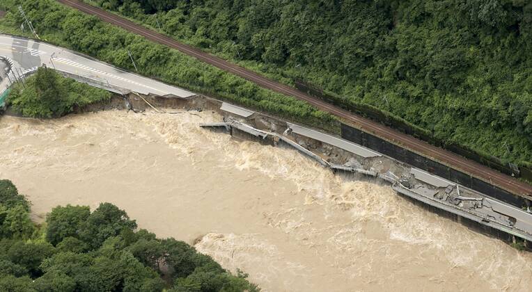 Torrential rain in central Japan Photo taken from a Kyodo News helicopter on July 8, 2020, shows a collapsed section of national road Route 41 after torrential rain caused the Hida River in Gero in Gifu Prefecture, central Japan, to swell.