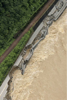 Torrential rain in central Japan Photo taken from a Kyodo News helicopter on July 8, 2020, shows a collapsed section of national road Route 41 after torrential rain caused the Hida River in Gero in Gifu Prefecture, central Japan, to swell.