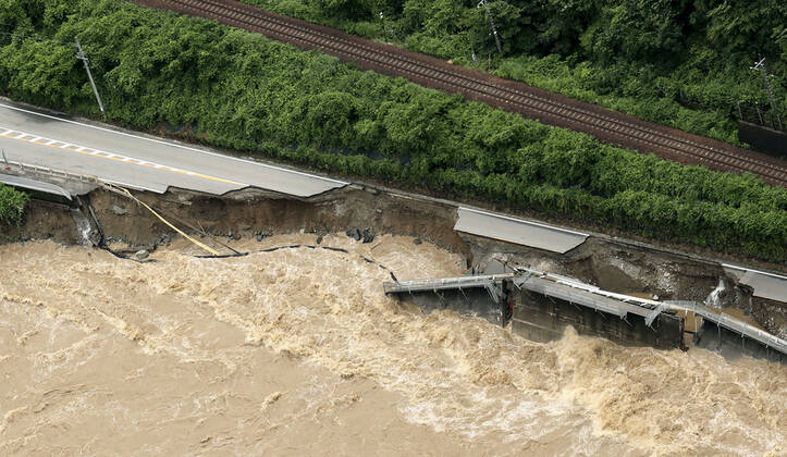 Torrential rain in central Japan Photo taken from a Kyodo News helicopter on July 8, 2020, shows a collapsed section of national road Route 41 after torrential rain caused the Hida River in Gero in Gifu Prefecture, central Japan, to swell.