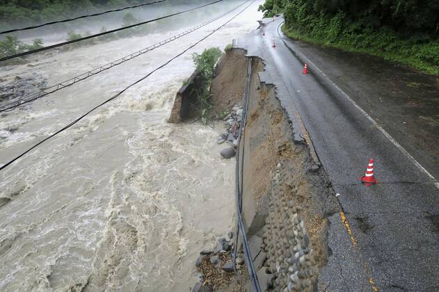 Torrential rain in central Japan Photo taken July 9, 2020, shows a collapsed section of a national road in Takayama in Gifu Prefecture, central Japan, following torrential rain.